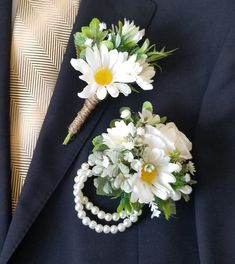 a man wearing a suit and tie with flowers in his lapel flower pinion