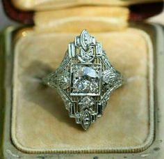 an antique diamond ring sits in a box