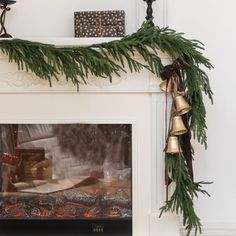 a fireplace decorated with christmas decorations and bells