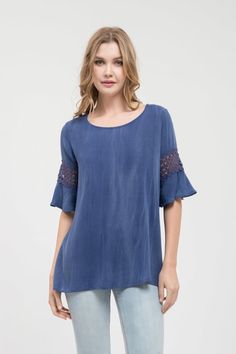 Round neck indigo top with lace sleeves 95% Rayon, 5% Spandex Casual Stretch Blouse With Lace Patchwork, Stretch Lace Patchwork Short Sleeve Tops, Stretch Lace Top With Lace Sleeves For Summer, Stretch Short Sleeve Tops With Lace Patchwork, Casual Short Sleeve Blouse With Lace Sleeves, Casual Blouse With Lace Short Sleeves, Blue Lace Patchwork Top For Spring, Casual Stretch Lace Top With Lace Trim, Casual Stretch Lace Top With Lace Sleeves