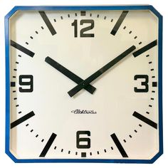 a blue and white clock with black numbers on it's face shows the time