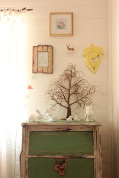 an old dresser with a tree on top