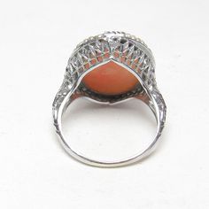 "MATERIAL: 14K white gold (marked). Top seems to be coated, but is still gold under it. WEIGHT: 4.7 grams CAMEOS: The ring holds a hand carved shell cameo. It is clean with no cracks. It measures 12 mm x 17.5 mm. RING SIZE: 5 (can be resized by your local jeweler) MEASUREMENTS: 7/8\" from north to south EXTRA: The ring is from the 1930's. The mount has a wonderful filigree design. The center holds a hand carved shell cameo. It shows a woman facing right. It is surrounded by natural seed pearls. Art Deco White Gold Jewelry With Cabochon, Art Deco Cabochon Ring For Anniversary, Heirloom White Gold Cabochon Ring, Art Deco Cabochon Rings For Weddings, Art Deco Cabochon Wedding Rings, Antique White Gold Rings With Cabochon, Victorian White Gold Rings With Polished Finish, Engraved Oval Filigree Ring In White Gold, White Gold Oval Filigree Ring Engraved