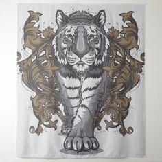 a white tiger with black and gold accents on it's face, standing in front of a wall hanging