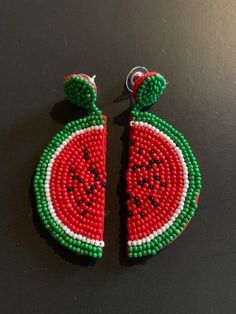 Fun 3" drop earrings hand-beaded in a watermelon slice design.  Post. A slice of summer that can be worn year-round, these hand-beaded earrings boast a bright red watermelon slice complete with green rind and black seeds.  Dangle length is 3" from post. 26-577 Green Summer Jewelry With Fruit Design, Watermelon Color Dangle Jewelry For Summer, Fun Colorful Beaded Earrings For Summer, Fun Beaded Earrings For Beach In Summer, Fun Green Beaded Earrings For Summer, Red Beaded Earrings As Summer Gifts, Green Beaded Earrings For Summer Fun, Handmade Watermelon Earrings For Summer, Handmade Watermelon Color Earrings For Summer