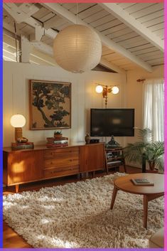 a living room filled with furniture and a flat screen tv on top of a wooden table