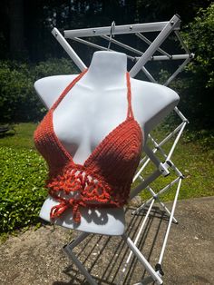 ☀️ Embrace the warmth of summer with our Handmade Orange Crochet Crop Top - a radiant creation that exudes vibrancy and handmade charm. Meticulously crafted, this crop top features a halter tie and a unique mesh-like accent, making it a standout addition to your wardrobe. 🧶 Handmade with love and attention to detail, each stitch in this orange crochet crop top reflects the artistry and dedication that goes into creating a one-of-a-kind piece. The sun-kissed orange hue adds a pop of energy, maki Orange Crochet Beach Top For Spring, Orange Crochet Top For Beach And Spring, Bohemian Crochet Lace Halter Top For Vacation, Handmade Hippie Crochet Top For Beach, Summer Festival Cotton Crochet Top, Beach Crochet Yarn Top, Summer Crochet Lace Top Made Of Yarn, Handmade Triangle Halter Top For Beach Season, Beach Crochet Top With Crochet Trim