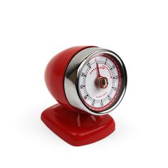 a red and white clock sitting on top of a stand