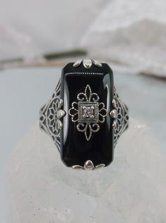 Black Glass/Stone & inset CZ, Moissanite, or Diamond Ring Grace Design#233 Custom Made I now offer this lovely Antique Art Deco/Edwardian design ring in sterling silver. This gorgeous ring is set with a stunning floral filigree embellished black glass/resin with a centered set 1mm white round cut gemstone (Choose White CZ, Lab White Moissanite, or Natural/Genuine White Diamond). The Black glass is 18mm Long by 19mm Wide. The ring sits 19mm North South on the finger and 10mm East West on the Beautiful Trinkets, Edwardian Design, Mystic Fire Topaz, Floral Filigree, Edwardian Style, Gem Diamonds, Gorgeous Ring, Gothic Rings, North South