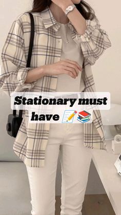 a woman standing in front of a white wall with the words stationery must have