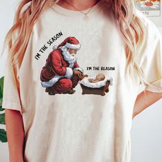 a woman wearing a t - shirt with santa clause on it