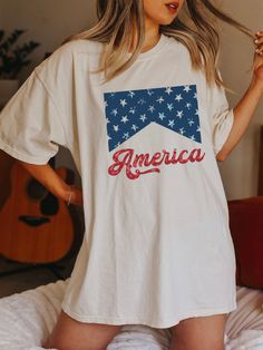 "FREE SHIPPING IN THE US! No order minimum!  Comfort Colors, Fourth of July Shirt, 4th of July Shirt, Independence Day, 4th of July, America Shirt, USA Tshirt, USA shirt, USA Flag Shirt ♥ The SHIRT  * This is a Comfort Colors 1717 shirt.  * This unisex t-shirt is intended to be loose/oversized for women to give a chic and laid back vibe. If you are looking for an oversized \"T-shirt Dress\" look, we recommend sizing up 2-3 sizes.  * Detailed sizing information can be found in the size chart in the photos.  * Printed in the USA. ♥ CARE  ＊Machine wash cold, inside-out, gentle cycle ＊Wash with mild detergent and similar colors ＊Tumble dry low or hang-dry ＊Do not bleach or fabric softeners ＊Do not iron directly onto the design ＊Do not dry clean ♥ PRODUCTION & SHIPPING ＊Each shirt is made to or 4th Of July Tops For Women, Cotton Crew Neck T-shirt With Flag Print, White Americana Letter Print T-shirt, Americana Cotton T-shirt With Letter Print, White Cotton T-shirt With American Flag Print, American Style Pre-shrunk Short Sleeve Shirt, Patriotic Short Sleeve T-shirt With Flag Print, Cotton Short Sleeve T-shirt, Relaxed Fit Letter Print Tops For 4th Of July