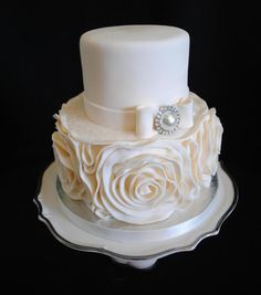 a wedding cake with white frosting and roses