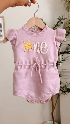 Beautiful birthday hand embroidered romper.  Celebrate your baby's big day with the cutest and happy sprinkles and confetti romper knitted romper with buttons on the bottoms for easy diaper change.  Handembroidered ☀️ne on it for the cutest first trip around the sun of your little sunshine baby.  Pink a color of your choice and feel free to customize to fit the colora of your party theme Custom order welcome Pink Onesie For Summer Birthday, Pink Onesie For Birthday In Summer, Pink Summer Birthday Onesie, Pink Onesie For Birthday In Spring, Cute Embroidered Bubble Romper For Spring, Cute Summer Onesie For Birthday, Fitted Summer Onesie For Birthday, Fitted Onesie For Summer Birthday, Embroidered Romper