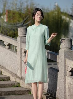 Experience the perfect blend of tradition and modernity with this elegant green qipao cheongsam dress. Made from Tencel fabric, this dress offers unmatched comfort and style, featuring a subtle bamboo leaves print that adds a touch of nature-inspired elegance. Features: Material: Crafted from Tencel fabric, known for its softness, breathability, and eco-friendliness. Design: The dress features a delicate bamboo leaves print, adding a serene and natural element to the overall look. Fit: Loose-fit Green Elegant Cheongsam With Stand Collar, Elegant Green Cheongsam With Stand Collar, Spring Green Cheongsam With Stand Collar, Green Stand Collar Cheongsam For Spring, Spring Cheongsam With Stand Collar For Tea Ceremony, Spring Cheongsam For Tea Ceremony With Stand Collar, Stand Collar Dress For Spring Tea Ceremony, Spring Ao Dai With Stand Collar For Tea Ceremony, Green Dresses For Tea Ceremony