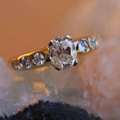 a diamond ring sitting on top of a rock