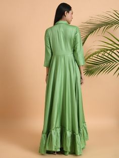 A shawl collared cotton silk maxi dress with flared and flounced bottom, side pockets, and long sleeves Garment measurements (in Inches): Small: Bust - 39", Waist - 29" Medium: Bust - 42", Waist - 32" Large: Bust - 45", Waist - 35" Length: 55-56", Sleeve length: 17" Fabric: Cotton Silk Color: Green Fit: Model height is 5'7" Model is wearing a size S Loose and comfortable fit. Instructions: Hand wash separately in cold water Note: Available in other colors Pants not included with the product Pant Elegant Floor-length Kurta For Spring, Spring Long Sleeve Gown With Ruffles, Green Long Sleeve Summer Gown, Festive Ruffled Maxi Dress, Fitted Long Maxi Dress With Ruffles, Festive Ruffled Long Sleeve Dress, Festive Maxi Dress With Ruffles, Festive Long Sleeve Dresses With Ruffles, Festive Long Sleeve Ruffled Dress