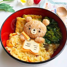 a teddy bear sitting on top of rice in a bowl with vegetables and other items