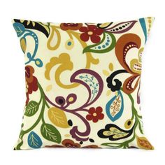 a decorative pillow with colorful flowers and leaves on the front, sitting on a white background