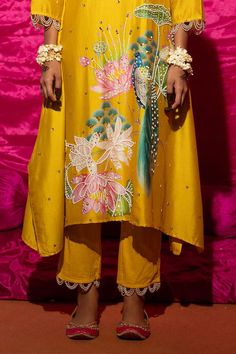 Yellow A-line kurta with floral placement print and sequin, pearl embroidery. Paired with pant and fringe lace bordered dupatta.
Components: 3
Pattern: Printed, Embroidery
Type Of Work: Floral, sequin, pearl
Neckline: Round
Sleeve Type: Long sleeves
Fabric: Chanderi Silk, Cotton, Lining: Shantoon
Color: Yellow
Other Details: 
Pearl embellished scallop border
Fringe tassel embellished bordered dupatta
Length:
Kurta: 45 inches
Pant: 38 inches
Occasion: Mehendi and Haldi - Aza Fashions Festive Silk Kurta With Printed Motifs, Designer Yellow Kurta With Printed Motifs, Designer Yellow Palazzo Set With Printed Motifs, Designer Wear Yellow Kurta With Printed Motifs, Designer Silk Salwar Kameez With Floral Embroidery, Designer Silk Palazzo Set With Printed Motifs, Silk Salwar Kameez With Floral Embroidery For Designer Wear, Semi-stitched Traditional Wear With Printed Motifs For Wedding, Silk Palazzo Set With Printed Motifs For Designer Wear