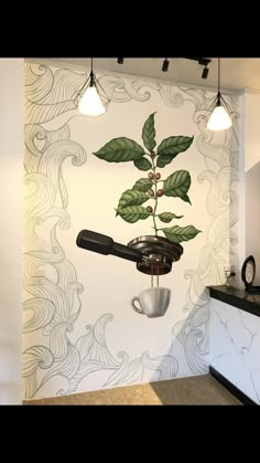 a coffee cup hanging from the side of a wall next to a plant with leaves on it