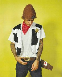 a man wearing a cow shirt and hat