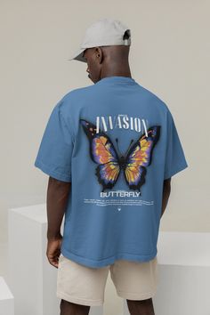 Introducing our Butterfly T-Shirt. Crafted from high-quality heavy cotton, this shirt embodies both comfort and style. The colorful butterfly back print adds a whimsical touch, perfect for those who love streetwear with a nature-inspired twist. Embrace your unique style and stand out with this eye-catching insect shirt that merges street fashion with the beauty of butterflies. 🌱 SAVING THE TREES WITH EACH PURCHASE 🌱 With every purchase you make, we pledge to plant a tree. Your support not only benefits the environment but also transforms lives. Join us in planting trees and making a positive impact. We appreciate your contribution! ✨ Quality ✨ Our clothing boasts 100% premium combed cotton, woven in a 32-count plain weave that's pre-shrunk for durability. Its heavyweight quality ensures Casual Butterfly Print T-shirt For Streetwear, Graphic Tee With Butterfly Print For Streetwear, Casual Butterfly Print Tops For Streetwear, Cotton Top With Butterfly Print For Streetwear, Blue Butterfly Print Short Sleeve T-shirt, Blue Short Sleeve T-shirt With Butterfly Print, Relaxed Fit Butterfly Print Graphic Tee, Casual Cotton Shirt With Back Print, Cotton Crew Neck Shirt With Back Print