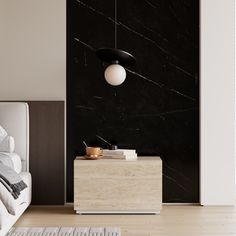 a white bed sitting next to a black and white wall mounted light on top of a wooden dresser