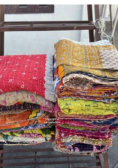 a pile of blankets sitting on top of a metal rack