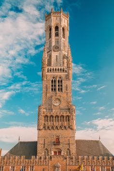 a tall tower with a clock on the front of it's face and windows