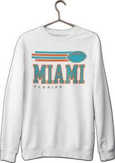 Long Sleeve Logo Print Tops For Fan Gear, White Retro Sweater With Letter Print, Retro White Sweater With Letter Print, Long Sleeve Logo Print Fan Apparel Top, Long Sleeve Varsity T-shirt For Fans, White Crew Neck Hoodie With Screen Print, Varsity Long Sleeve T-shirt For Fan Merchandise, White Crew Neck Sweater For College, Long Sleeve Fan Apparel Top With Logo Print