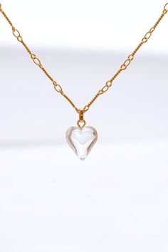 This stunning set features a beautifully crafted heart-shaped pendant adorned with shimmering crystal, hanging gracefully from a delicate gold chain. The matching earrings mirror the pendants' design, offering a perfect balance of sophistication and charm. Ideal for both everyday wear and special occasions, this set effortlessly enhances any outfit with a touch of timeless glamour. Handmade item 18k gold plated brass Syn crystal Hypoallergenic 925 silver post Necklace length: 42cm+6cm extension Elegant Gold Heart Pendant Crystal Necklace, Elegant Gold Crystal Necklaces For Valentine's Day, Gold Double Heart Crystal Jewelry, Elegant Crystal Heart Pendant Necklace, Gold Crystal Heart Pendant Jewelry, Gold Crystal Heart Pendant Necklace, Gold Crystal Heart Necklace, Gold Crystal Necklace With Heart Charm For Gifts, Clear Heart Pendant Jewelry As Gift