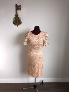 Leslie Fay Evenings - Vintage peach / gold, lace, evening dress.  Beautiful, classic lace dress, in a soft peach color, with gold accents.  Perfect for any evening occasion, or fancy daytime event!   Size 6 (or 4) For every item purchased, an item will be donated. Elegant Fitted Gold Lace Dress, Elegant Gold Fitted Lace Dress, Gold Lace Party Dress, Elegant Fitted Apricot Dress, Gold Party Dress With Lace Trim, Elegant Fitted Peach Dress, Elegant Peach Fitted Dress, Vintage Beige Lace Dress For Party, Elegant Apricot Dress For Parties