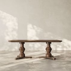 a wooden table sitting on top of a cement floor