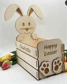 a wooden bunny rabbit sitting in a crate