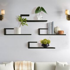 a living room filled with lots of furniture and decor on top of a white wall