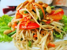 a white plate topped with noodles and vegetables