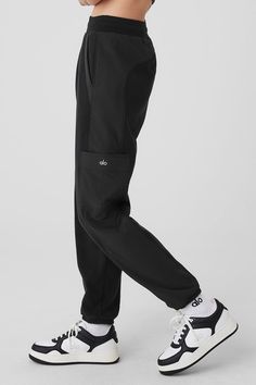 Made from a fleecy-soft fabric with smooth, contrasting panels down the legs, these pants are every bit as cozy as they look. They have a total of 4 pockets—2 on the sides, 2 on the legs—plus a stretchy high-rise waistband and stretchy cuffed hems for a jogger-style fit. Our advice? Get the matching jacket, too. Alo Yoga Relaxed Fit Sweatpants With Pockets, Black Joggers With Tapered Leg And Pockets, Black Tapered Leg Joggers With Pockets, Alo Yoga Relaxed Fit Pants With Pockets, Black Sportswear Pants With Cargo Pockets, Black Cargo Pants For Sportswear, Black Tapered Joggers With Hip Pockets, Functional Black Joggers With Side Pockets, Sporty Black Joggers With Cargo Pockets