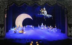 the stage is set for an animated show with people dressed in white and blue costumes