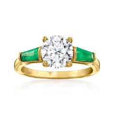 a yellow gold ring with an emerald and white diamond