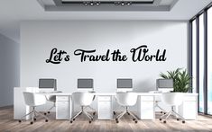 there is a wall decal that says let's travel the world