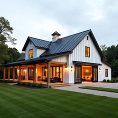 a large white house sitting on top of a lush green field