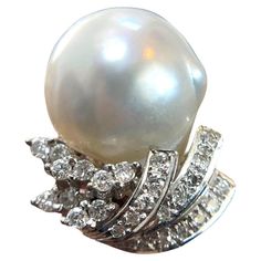 Indulge in luxury with this 14K White Gold Diamond Pearl Ring. Weighing 9 grams and perfectly sized at 5.5, this exquisite piece features a radiant pearl surrounded by sparkling diamonds, all set in solid white gold. A timeless addition to any jewelry collection. Weight: 9 g Size: 5.5 Material: 14K Solid White Gold Sell Price: $999 Appraisal Price: $2000 A free Online Diamond appraisal is included upon request Luxury Exquisite Diamond Pearl Ring, White Pearl Ring With 17 Jewels For Formal Occasions, Formal White Pear-shaped Diamond Ring, Formal Diamond Pearl Ring With High Luster, White Pearl Ring With Diamond Accents In Platinum, White Pearl Platinum Ring With Diamond Accents, White Gold Pearl Ring With High Luster Diamonds, Diamond Pearl Ring, Pearl And Diamond Ring