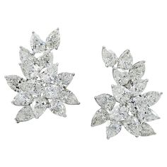 If you are getting ready for gala season, which in New York City, runs from Fall through Spring, you might be searching for a quintessentially elegant pair of diamond earrings to frame your face in radiance. This stunning pair of Spectra Fine Jewelry Diamond Cluster Button Earrings, made in the 21st century are perfect for your big night out. The sparkling mirror-image pair is crafted in platinum and features 30 pear-shape diamonds with an estimated weight of 29.25 carats total. Nine of the thirty diamonds which weigh around one carat apiece are certified by the Gemological Institute of America (GIA), stating that some are of D-E-F color, some G-H with a clarity range that includes VS2 and SI1- SI2. Individual reports will be provided to interested buyers. The three-dimensional jewels capt Real Diamond Earrings, Diamond Earrings Studs Round, Diamond Cluster Earrings, Antique Earrings, Pear Shaped Diamond, Cluster Earrings, Diamond Bracelets, Diamond Cluster, Gia Certified Diamonds