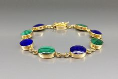 "Bracelet classic oval Lapis Lazuli and Malachite with solid 18K gold. Unique gift for her, girlfriend, wife, September and December birthstone, 9 year anniversary. A classic all time favorite in design and color. The stones are nicely arranged with a continuous color scene and perfect craftsmanship. This beautiful Bracelet is worked with the technique of inlay, which means the stone is worked seamlessly into the 18K gold. All our stones are natural stones and our jewelry is handmade, slight dif 9 Year Anniversary, Brooch Jewelry, Gold Gift, Unique Gifts For Her, December Birthstone, Chain Link Bracelet, Beautiful Bracelet, Lapis Lazuli, Turquoise Bracelet