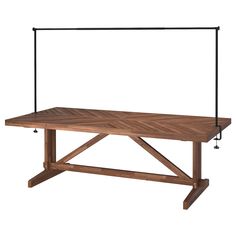 a wooden table with metal legs and an iron bar on the top, against a white background