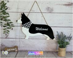 a wooden sign with a dog wearing a bandana hanging from it's side