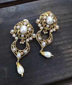 If you like to make a statement with your jewelry then this is the piece to own Lightweight statement earrings 3.5 inches long.from top of earring to tip of bead. Gold plated for a rich finish. They are studded with cultured white Pearls. A beautiful One of a kind piece. It takes around 2 weeks to hand make a piece like this. This is a designer piece. Only made exclusively for royal exquisite jewelry lovers Thank you for your appreciation www.taneesi.com These earrings will be shipped with deliv Elegant Metal Chandbali Bridal Earrings, Elegant Chandbali Bridal Earrings In Metal, Elegant White Chandbalis For Wedding, Elegant Metal Chandbalis With Intricate Design, White Bollywood Chandelier Earrings With Intricate Design, Bollywood Style White Chandelier Earrings With Intricate Design, Elegant Chandbali Chandelier Earrings For Wedding, White Chandelier Earrings With Intricate Design For Celebration, White Bollywood Bridal Earrings For Formal Events