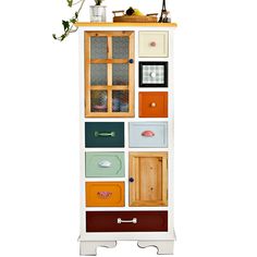 a tall wooden cabinet with many drawers on it's sides and doors in different colors