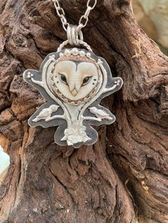 "This unique owl art pendant features a porcelain Grace owl face (larger than the Featherhead owl) set in solid sterling silver and framed by 2 branches with birds and a flower base.  It is embossed on the back with a woodland pattern and also has a silver butterfly. I have several types of owls in the woods behind my home.  We often hear the bigger ones hoot but seeing them is rare even when you know they are so close.  Thus the name \"hidden in plain sight\".   This art pendant is approximatel Types Of Owls, Goddess Crystals, Woodland Pattern, Owl Face, Flower Base, Hidden In Plain Sight, Sterling Silver Owl, Crystal Goddess, Silver Owl